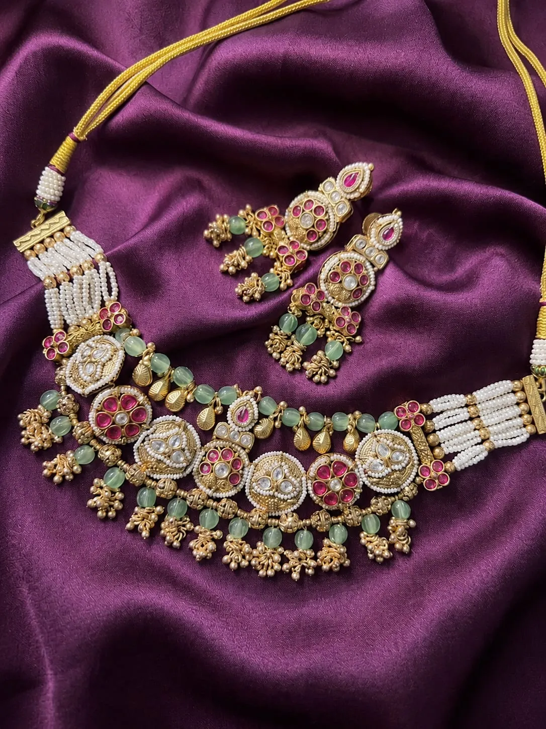 Rajsi Heritage Premium Necklace Set — Gold polish with intricate detailing, Pearl-style beads and green stones and pink stones and CZ stones