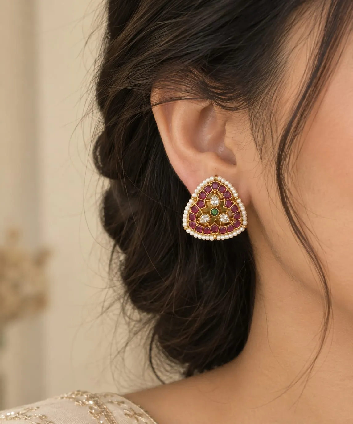 Triveni Ruby Bloom Studs — Gold finish with intricate detailing, Red synthetic ruby-style stones and green synthetic stone and cubic zirconia (CZ) clear stones